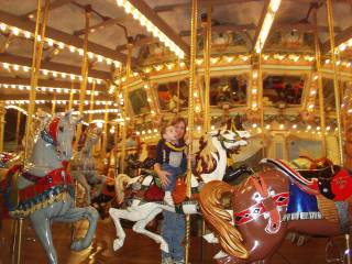 Colton riding a carousel